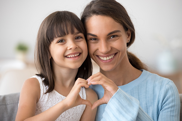 Mother and daughter smiling